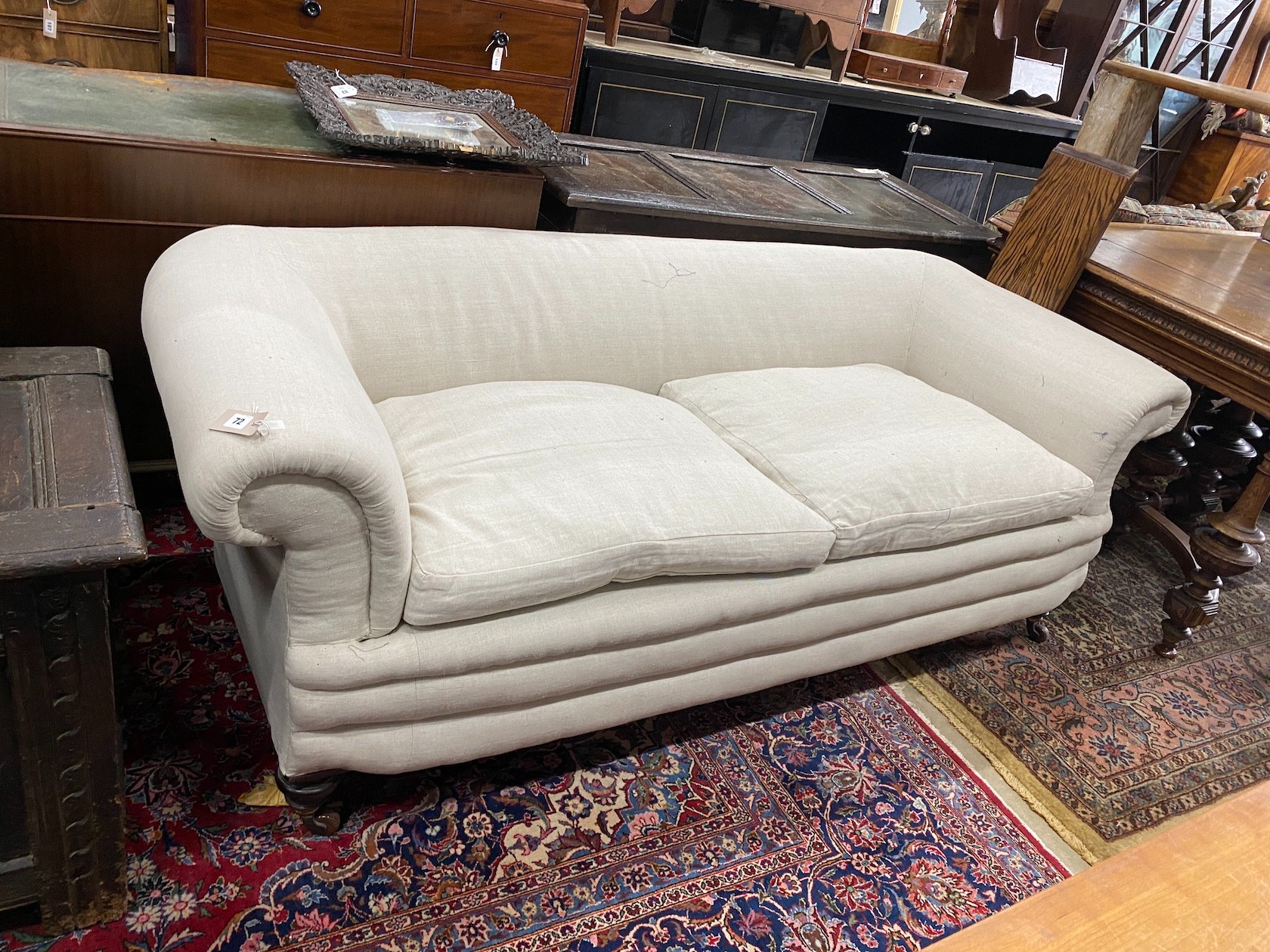 A late Victorian Howard style Chesterfield settee upholstered in natural fabric, length 190cm, depth 78cm, height 66cm